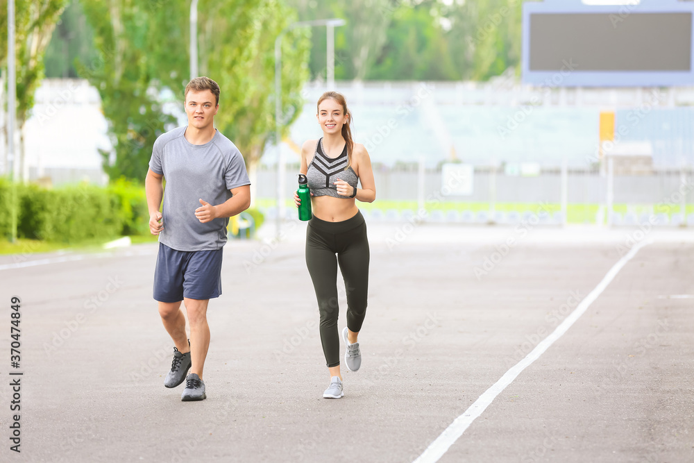 Sporty young couple running outdoors