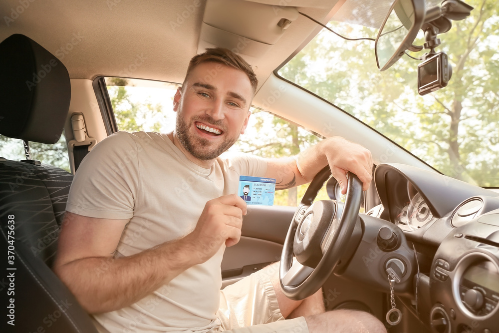 Happy young man after successful passing of driving license test
