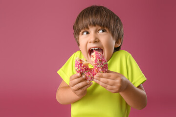 Poster - Funny little boy with donut on color background