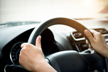 Woman's Hand Holding A Car Steering Wheel,represents The Correct Car Steering Wheel. In Order To Prevent Accidents. Show Driving Safe Step.