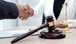 © Orathai - shake hand Professional male lawyers work at a law office There are scales, Scales of justice, judges gavel, and litigation documents. Concepts of law and justice
