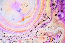 Colorful Rainbow Bath Foam With Bubbles In The Water. Galaxy Imagination. Marble Texture Effect. Beauty And Luxury Background. Flat Lay, Top View