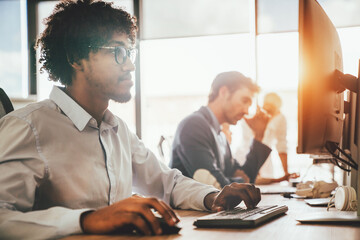 Programmers cooperating at IT company developing apps
