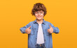 Happy schoolboy in jeans shirt showing thumbs up