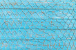 Fishing net over rustic blue wood, nautical maritime background