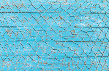 Fishing net over rustic blue wood, nautical maritime background