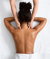 Wall Mural - Female therapist massaging black woman neck, top view