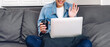 Young smiling happy beautiful asian woman relaxing using laptop computer working and video conference meeting at home.Young creative girl say hi and typing on keyboard.work from home concept