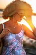 © Ann Stryzhekin - Portrait of a tanned woman in a straw hat on nature at sunset. Selective soft focus.