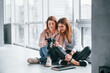 © standret - Two women sitting indoors together and looks at photos on the camera
