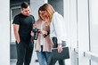 © standret - Group of people standing indoors together and looks at photos on camera