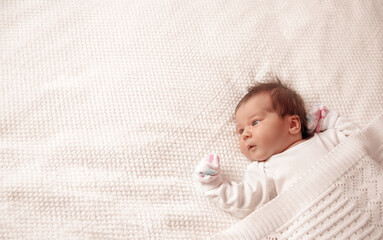 Wall Mural - Cute newborn baby girl lying in the bed