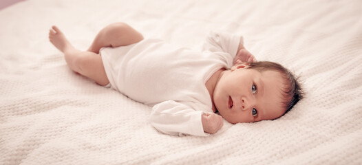 Wall Mural - Cute newborn baby girl lying in the bed