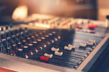 Professional audio mixing console with faders and adjusting knobs, TV equipment selective focus