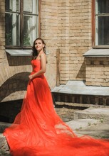 Evening Dresses Concept, Elegant Fancy Style. Woman In Evening Red Dress. Clothes For Ladies, Inspiration 