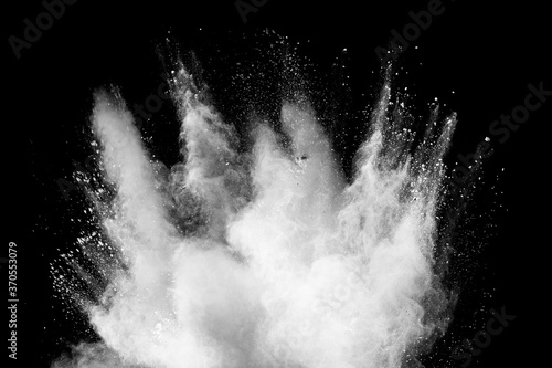 Cuadros en Lienzo Freeze motion of white dust particles splash on black background.