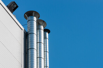 silver metal hoods on a building wall.