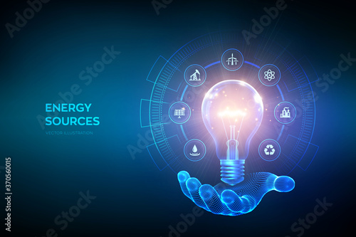 Glowing light bulb with energy resources icons in hand Poster Mural XXL