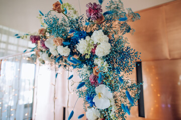 Poster - A beautiful bouquet of blue and white flowers of hydrangeas, roses and orchids on the wedding arch. Ideas for wedding decor