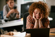 © JustLife - Tired businesswoman working on laptop. Young businesswoman working in the office..