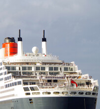 Rear View Of Stern And Superstructure With Red Funnel Of Legendary Ocean Liner Or Cruiseship Or Cruise Ship Liner QM2 Or Queen Mary 2