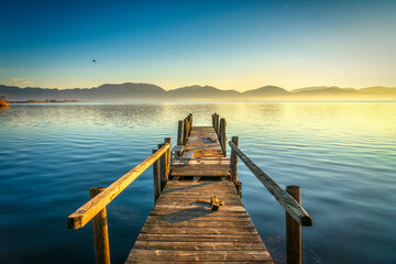  Wooden pier or jetty and lake at sunrise. Torre del lago Puccini Versilia Tuscany, Italy
