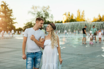 couple in the city square with fountains