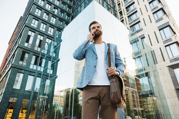 Wall Mural - Young urban businessman on smart phone