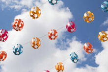 Colored Paper Lanterns Set Against Blue Sky