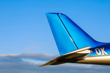 Wall Mural - Tail of a small 2-seater aircraft against a blue sky. Close up.