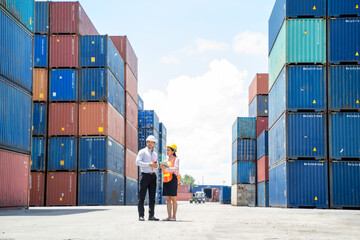 Manager and contenner worker working in the construction container yard,Industrial container yard for import and export for business concept.