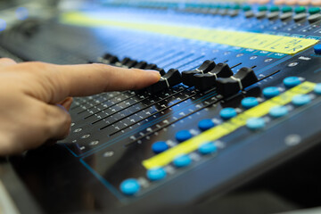 Sound recording studio mixing desk with engineer or music producer  with side view selective focus.