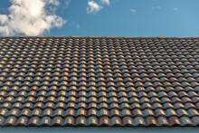 Pattern Of Tiles On A Roof Against Blue Sky