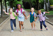 © Evgeniy Kalinovskiy - small schoolchildren with colorful school bags and backpacks run to school. Back to school, education, elementary school.