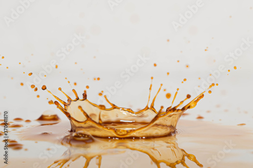 splash de gotas de liquido oscuro café o te en alta velocidad con fondo blanco