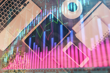 Double exposure of forex chart hologram over desktop with phone. Top view. Mobile trade platform concept.