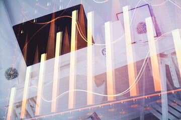 Double exposure of financial graph drawing and office interior background. Concept of stock market.