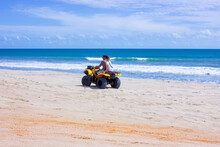 Young Couple Riding An ATV On Brazil Beach