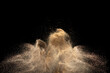 Gold sand explosion isolated on black background. 