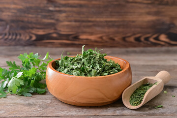 Bowl with dry parsley on table