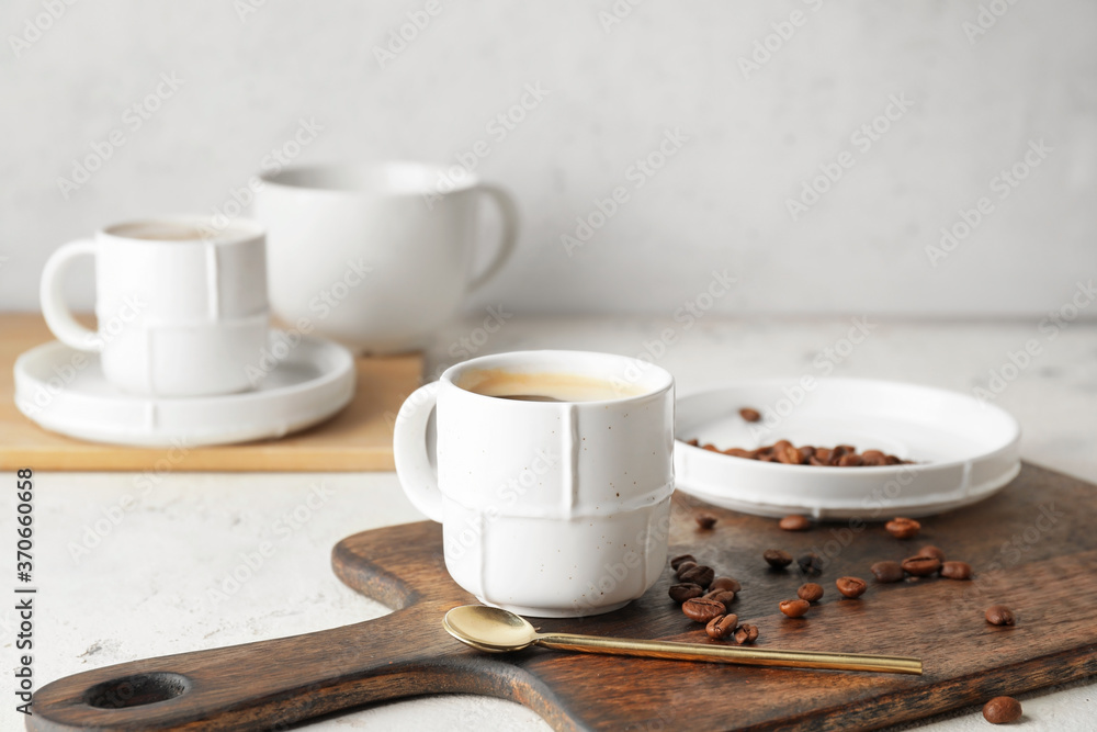 Cup of hot coffee on table