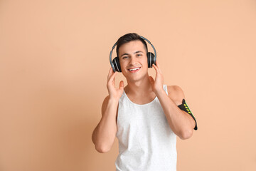 Sticker - Sporty young man with headphones on color background