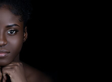 Close Up Of Beautiful Young Black Woman With Beautiful Skin And Makeup Looking At Camera