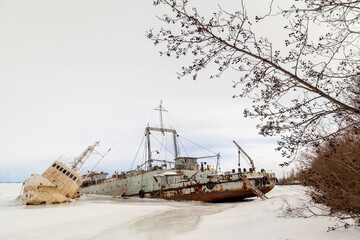 Frozen ship graveyard with two rusty industrial ships