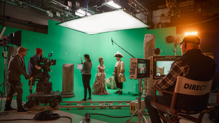 On Big Film Studio Professional Crew Shooting History Costume Drama Movie. On Set: Director Controls Cameraman Shooting Green Screen Scene with Two Actors Talented Wearing Renaissance Clothes Talking