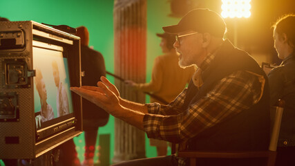 Wall Mural - Director Looks at Display in Anger, Swears while Shooting Blockbuster Movie. Green Screen Scene with Actors Wearing Costumes. On Film Studio Set Professional Crew Doing High Budget Movie