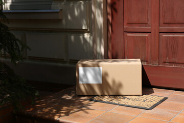 Wall Mural - Delivered parcel on door mat near entrance