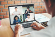 © joyfotoliakid - Asian man working from home use Smart working and video conference online meeting with Asian team using laptop and tablet online in video call for new projects