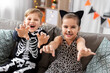 © Syda Productions - halloween, holiday and childhood concept - smiling little boy and girl in party costumes having fun at home