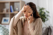 © Syda Productions - technology, health and cold concept - sick asian woman having headache calling on smartphone at home